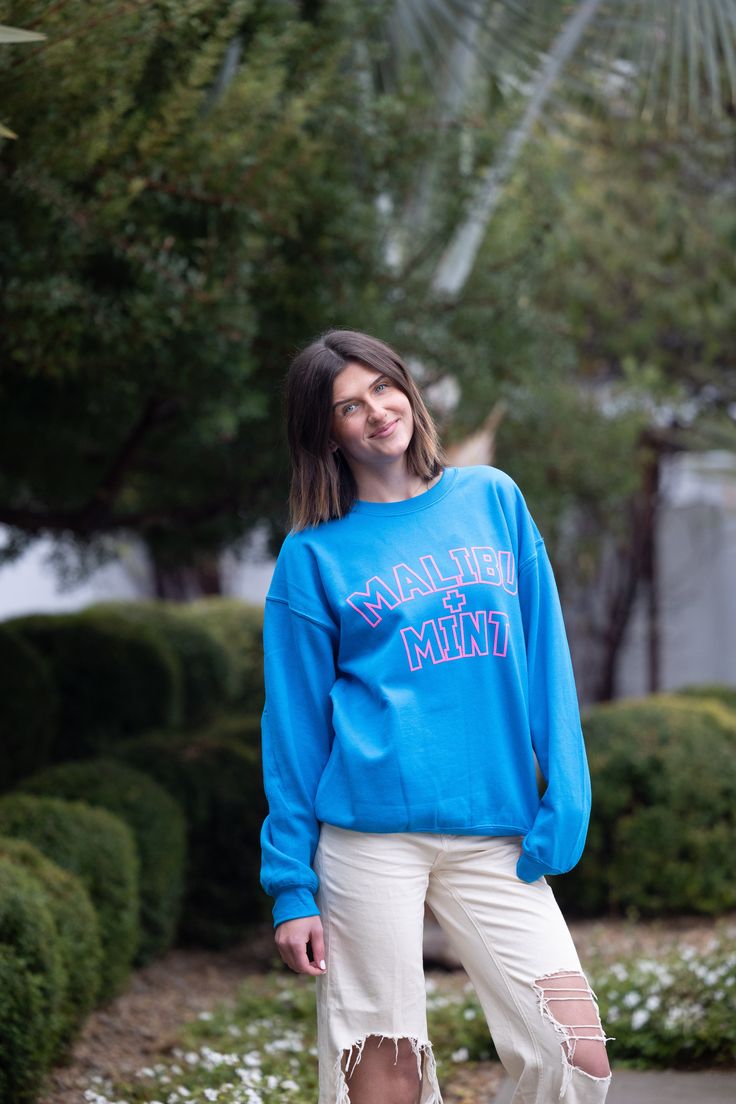 Introducing our Malibu and Mint Sweatshirt, a perfect blend of comfort and coastal vibes for those who embrace the sun, sand, and sea. Crafted with soft, breathable fabric, this sweatshirt is your go-to companion for breezy beach days or cozy evenings by the bonfire. The design captures the essence of pure joy with playful and vibrant hues that reflect the cheerful spirit of beach life. Embrace the sunshine in style and spread positive vibes with this Malibu and Mint Sweatshirt – where comfort meets the carefree allure of the ocean. *For an oversized fit, size up 1-2 sizes* **Washing Instructions: For best results, wash garment inside out in cold water. Avoid hot water to preserve fabric quality. Hang to dry to maintain shape and color vibrancy. Do not tumble dry or bleach. Sporty Summer Sweatshirt For Leisure, Sporty Summer Leisure Sweatshirt, Casual Blue Sweats With Letter Print, Comfortable Blue Top For Leisure, Comfortable Blue Tops For Leisure, Blue French Terry Crew Top, Blue Cotton Leisure Sweatshirt, Casual Blue Soft-washed Sweatshirt, Blue Cotton Sweatshirt For Leisure