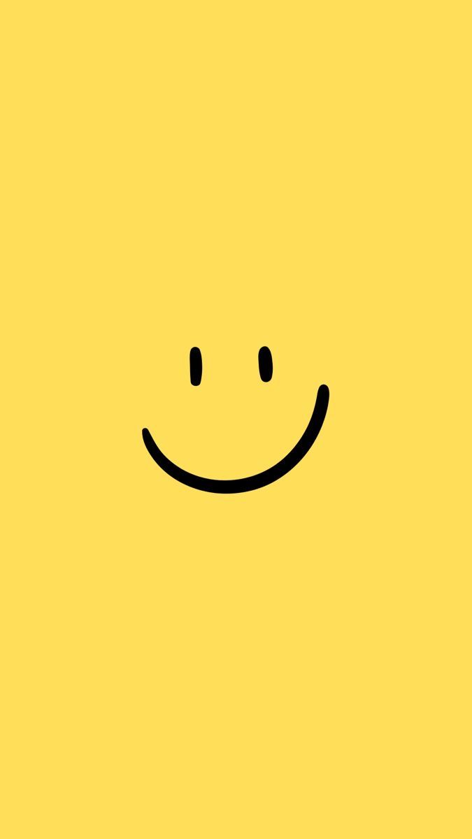 a yellow background with a smiley face drawn on it