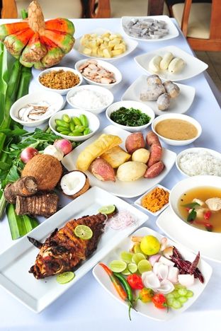 a table topped with lots of different types of food on plates and bowls next to each other