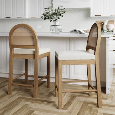 two wooden chairs sitting next to each other on top of a hard wood floor in a kitchen