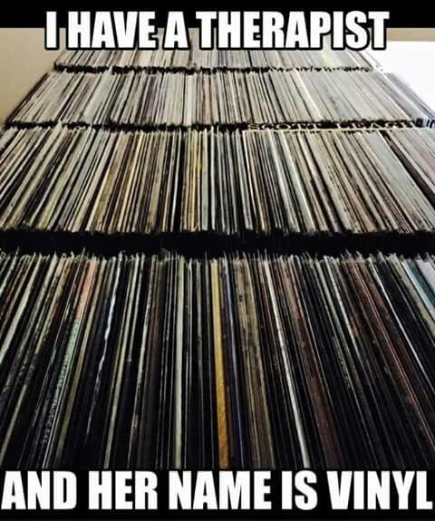 a pile of records sitting on top of a table