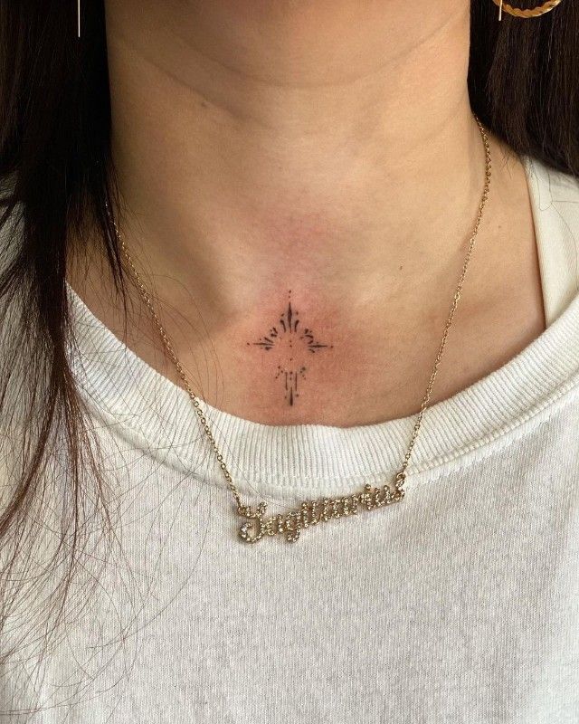 a woman with a cross tattoo on her chest