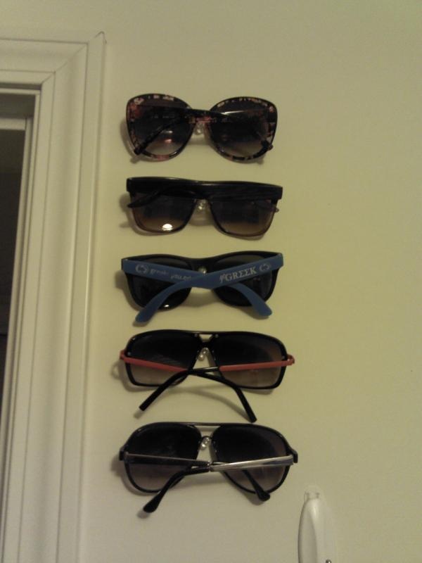 five pairs of sunglasses hanging on the wall