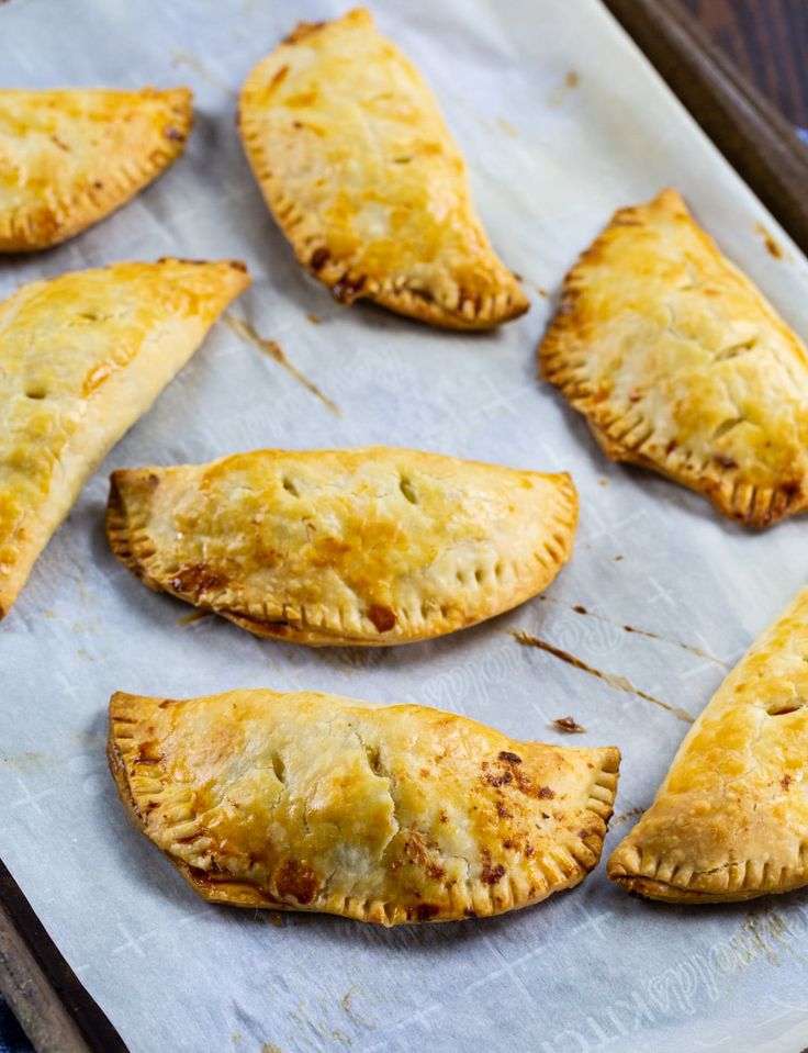 several pastries are on a baking sheet ready to be baked in the oven,