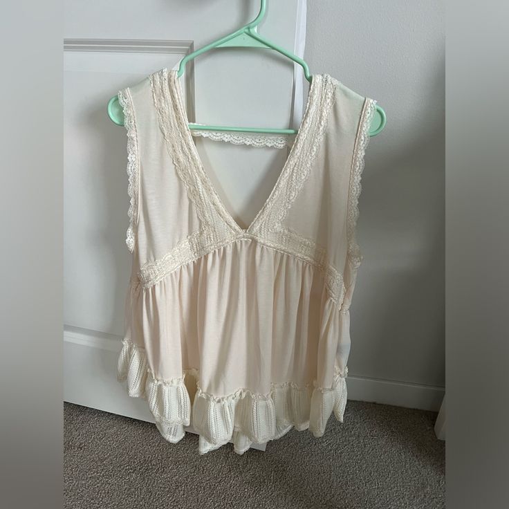 Cute Ruffle Trimmed Top By Pol With Lace Back Strap. Size Is Large. Color Is Vanilla. Feminine Ruffle Hem Tank Top, Beige Ruffled Tank Top For Summer, Feminine Summer Tank Top With Ruffle Hem, Casual Sleeveless Tank Top With Ruffle Hem, Bohemian Sleeveless Ruffle Blouse, Bohemian Sleeveless Ruffled Blouse, Sleeveless Cotton Tank Top With Ruffle Hem, Cotton Sleeveless Tank Top With Ruffle Hem, Cotton Ruffle Hem Sleeveless Tank Top