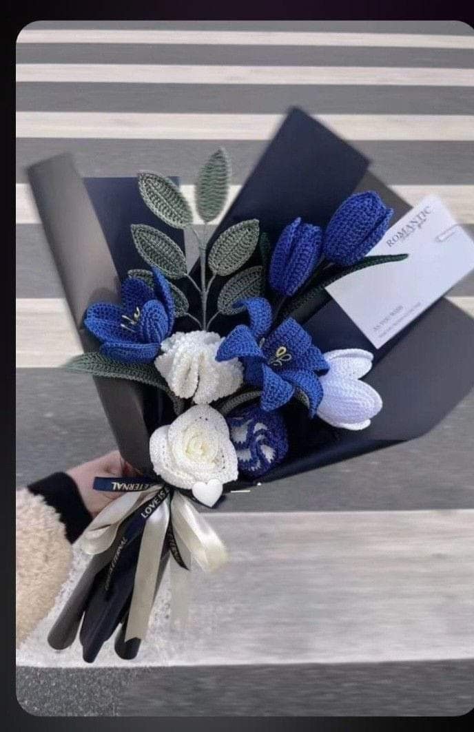 a bouquet of blue and white flowers in a box