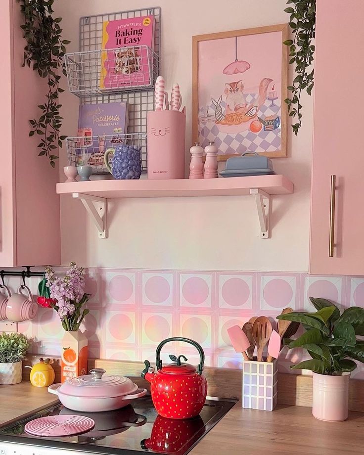 a kitchen with pink walls and wooden counters, potted plants on the stove top