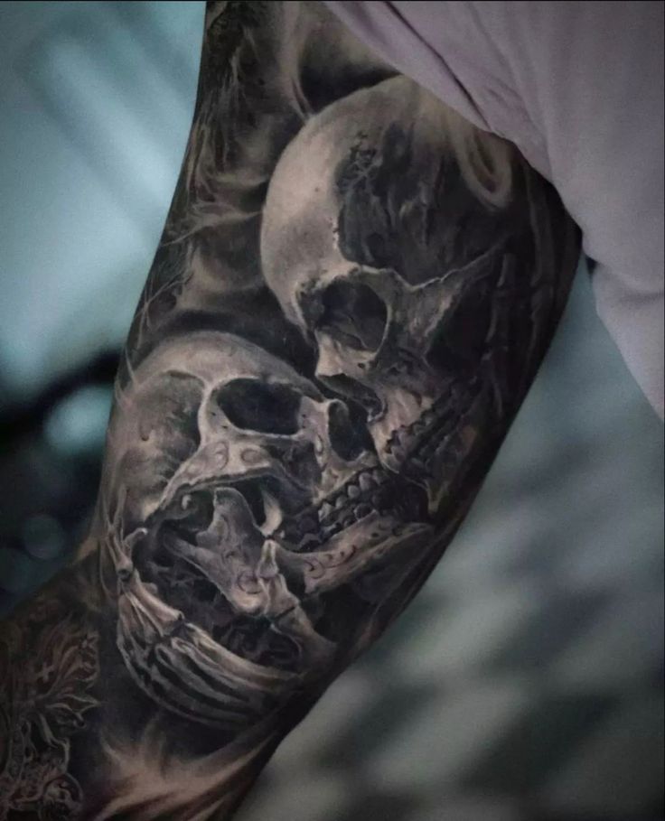 a man's arm with two skulls on it