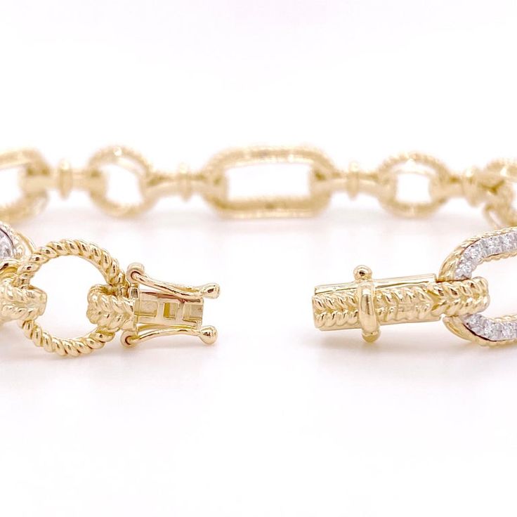 This bracelet is the perfect addition to any fine jewelry collection! The design has pave diamond links alternating with beaded gold links, giving the bracelet a versatile and unique look. The diamonds are bright white, adding contrast next to the rich, yellow-gold links. The beaded texture allows light to reflect off this bracelet from every angle making the bracelet shimmer in any setting! Metal Quality: 14KLength: 7 inchesWidth: 9.5 millimetersClasp: Hidden Box ClaspDiamond Shape: Round Brill Luxury Diamond Bracelet With Solid Link For Anniversary, Elegant Gold Chain Bracelet With Diamond Accents, Luxury Cubic Zirconia Diamond Bracelet With Oval Links, Luxury Chain Bracelet With Pave Setting For Anniversary, Luxury Pave Setting Chain Bracelet For Anniversary, Luxury Link Diamond Bracelet For Anniversary, Luxury Diamond Link Bracelet For Anniversary, Luxury Oval Link Bracelet With Diamond Accents, Fine Jewelry Diamond Tennis Bracelet