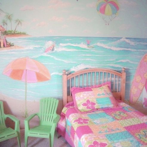 a child's bedroom decorated in pink, green and blue with a beach scene painted on the wall