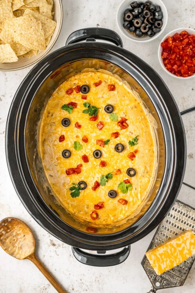 an overhead view of a crock pot with tortilla and salsa in it