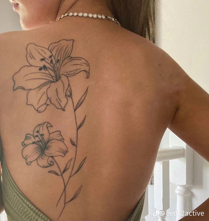 a woman with a flower tattoo on her back