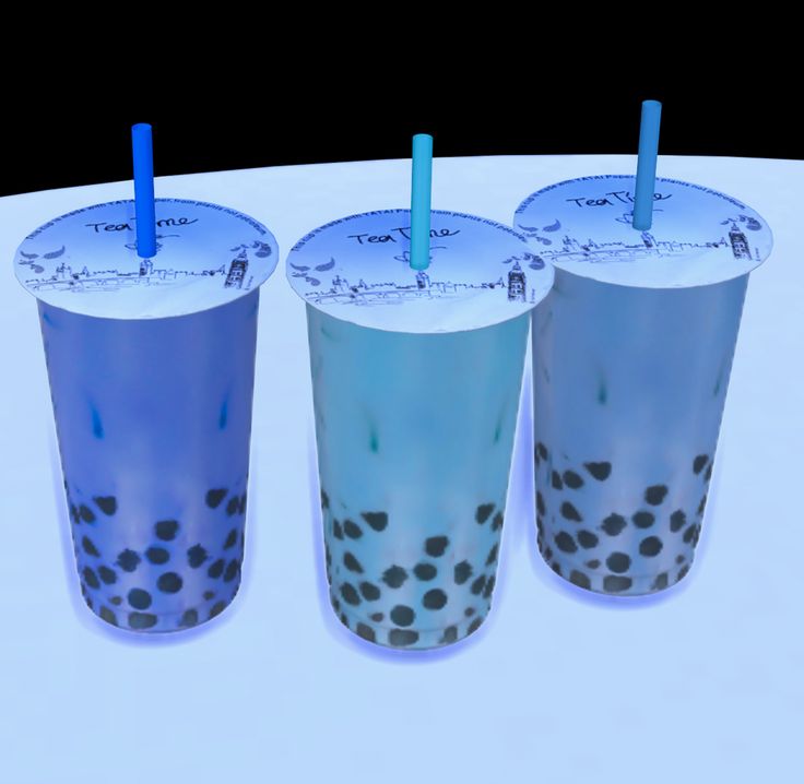 three blue cups with straws in them sitting on a white table top next to each other