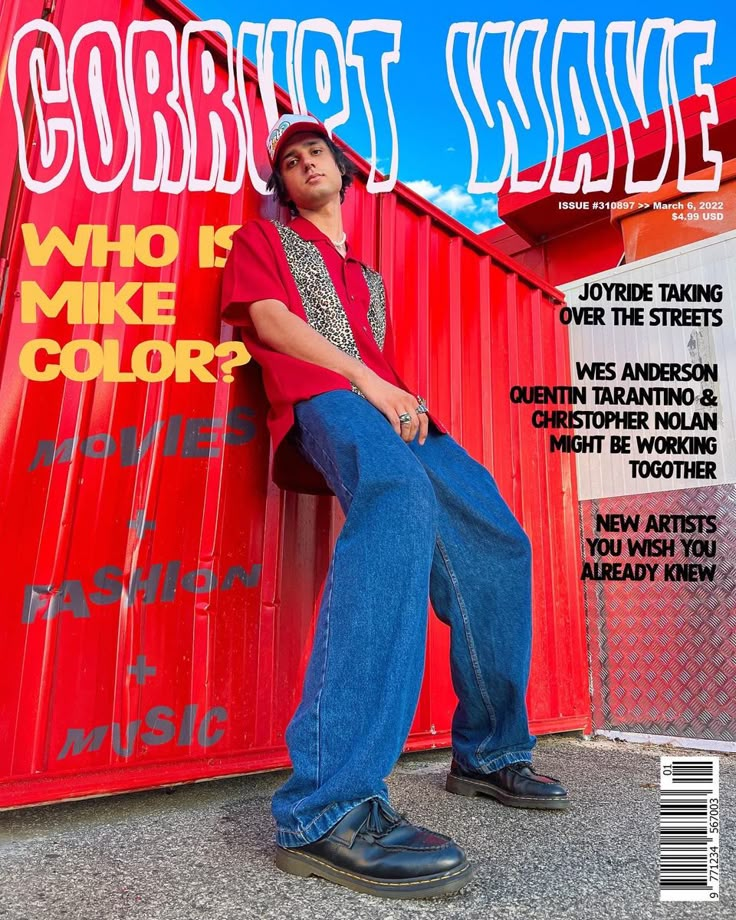 a man sitting on top of a magazine cover next to a red wall with graffiti