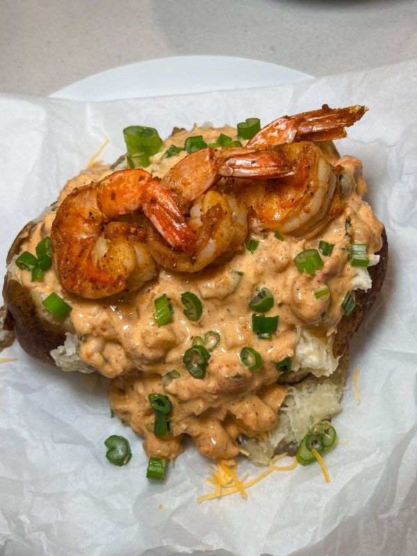 a plate with some food and shrimp on it