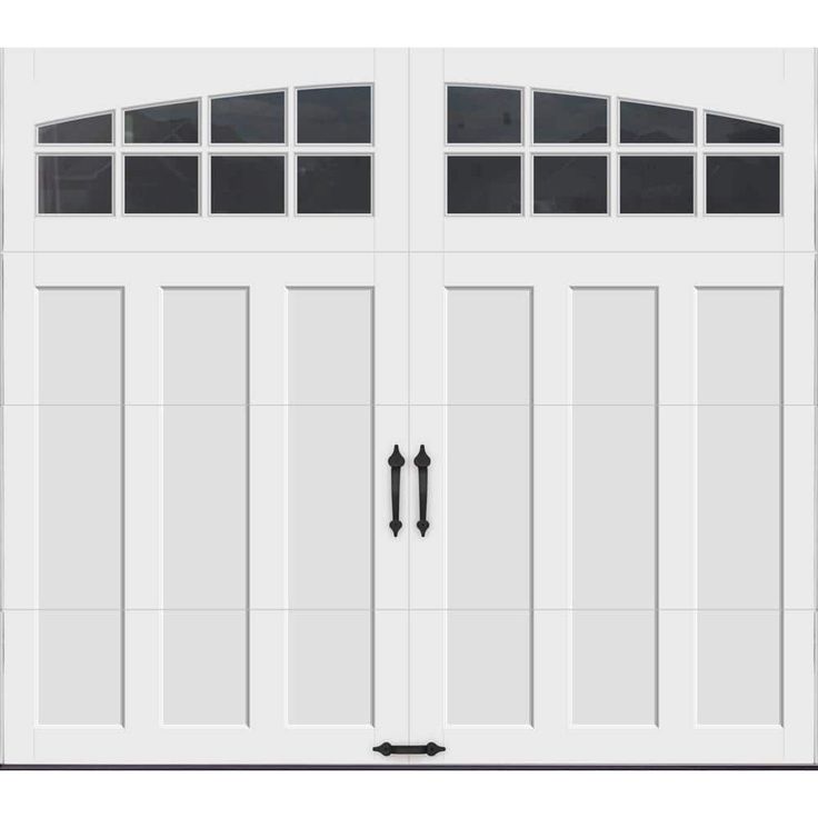 a white garage door with three windows