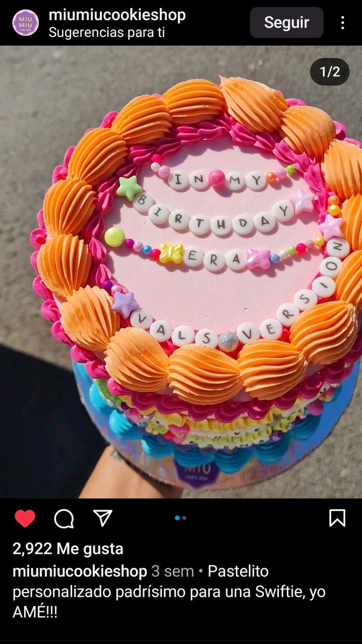 an image of a cake that is decorated with letters and hearts on it's side