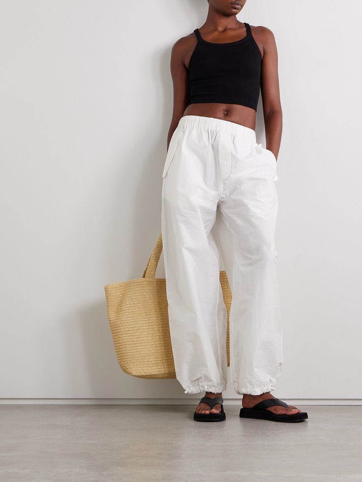 WARDROBE.NYC's 'Beach' track pants have a carefree, easy vibe. Made from crisp cotton-blend shell, they have an elasticated waistband and breezy legs that taper at the ankles - use the adjustable toggles to customize the fit. White Cotton Parachute Pants, White Ankle-length Beach Pants, White Wide-leg Parachute Pants For Loungewear, Luxury Wide-leg Cotton Parachute Pants, White High-waisted Parachute Pants With Elastic Waistband, Denim Flats, Relax Pants, Exclusive Dress, Sports Skirts