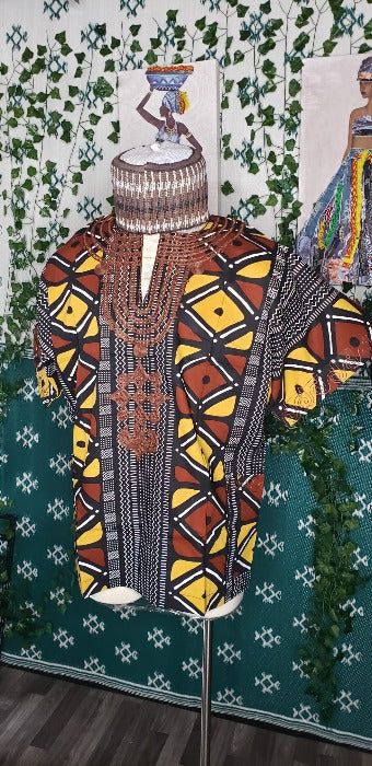 Elevate your wardrobe with our Fulani Dashiki TOP . Made from lightweight wax cotton, the loose fit and embroidered details on the neckline, chest, sleeves, and pocket exude elegance and comfort. Experience the luxury of our Fulani Embroidered pieces. made in Nigeria. Combination Dresses, Embroidered Details, African Wear, Waxed Cotton, Wax, Wardrobe