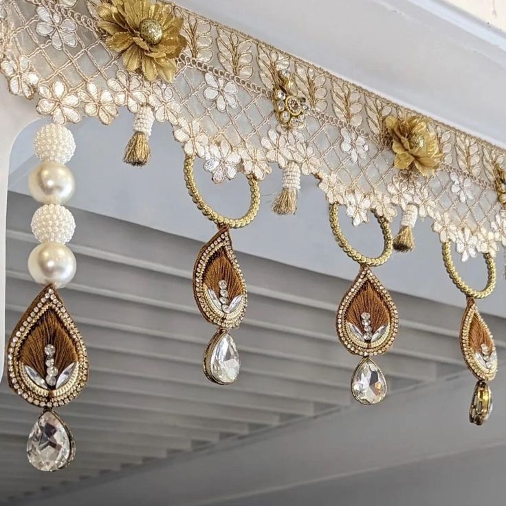 the beaded curtains are hanging from the ceiling with pearls and other beads on them