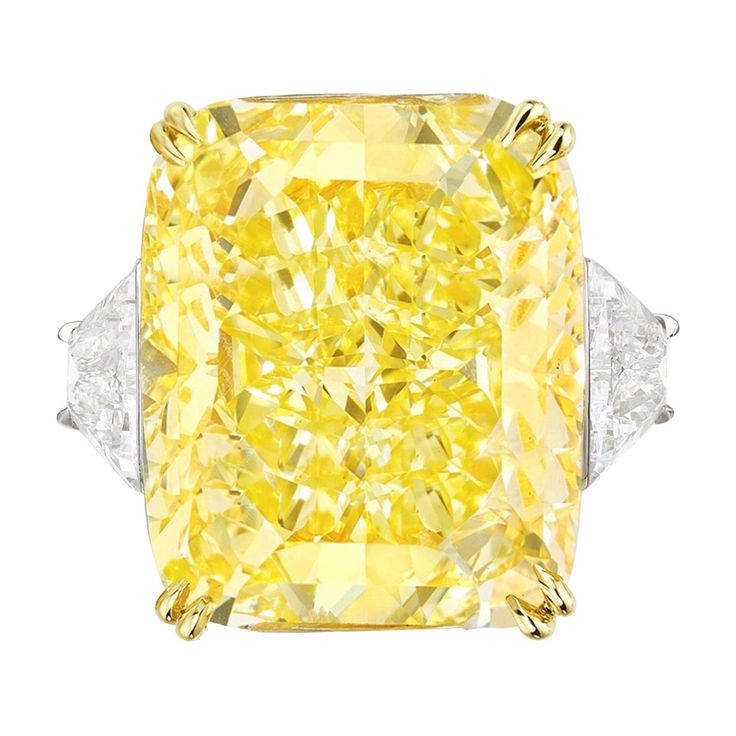 Radiate unparalleled elegance with this GIA Certified 10.05 Carat Fancy Yellow Radiant Cut Diamond Ring, adorned with trapezoid diamonds on the side. At the heart of this magnificent ring gleams a captivating cushion-cut diamond, certified by the esteemed Gemological Institute of America (GIA) for its exceptional quality. Despite being classified as Fancy Yellow, this diamond exudes a brilliance and warmth that is truly enchanting. With a Clarity Grade of VS2, the diamond showcases impeccable clarity, allowing light to dance through its facets with mesmerizing allure. Crafted with meticulous precision, the diamond displays Excellent Polish and Excellent Symmetry, ensuring each facet reflects light with stunning brilliance and precision. Enhanced by its none fluorescence, the diamond's natu Rings Fancy, Glitter Rocks, Fancy Yellow Diamond Ring, Radiant Cut Diamond Ring, White Engagement Ring, Jewelry Fancy, Yellow Diamond Ring, Yellow Ring, Oval Diamond Ring