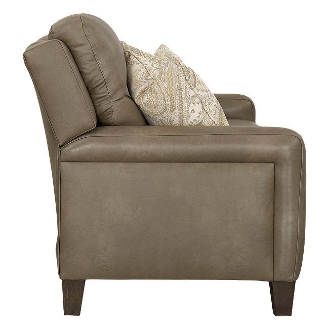 a gray chair with pillows on top of it