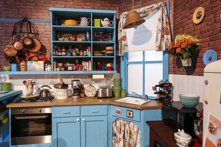 a kitchen with blue cabinets and wooden counter tops