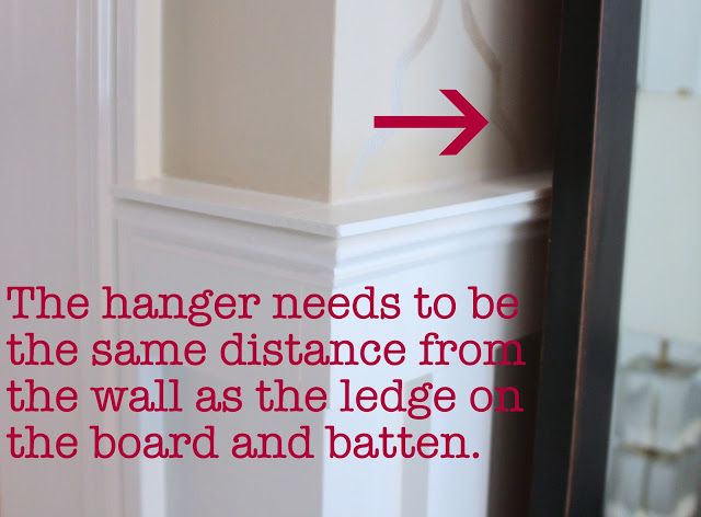 the corner of a room with a red arrow pointing to the wall that says, the hanger needs to be the same distance from the wall as the edge on the board and batten