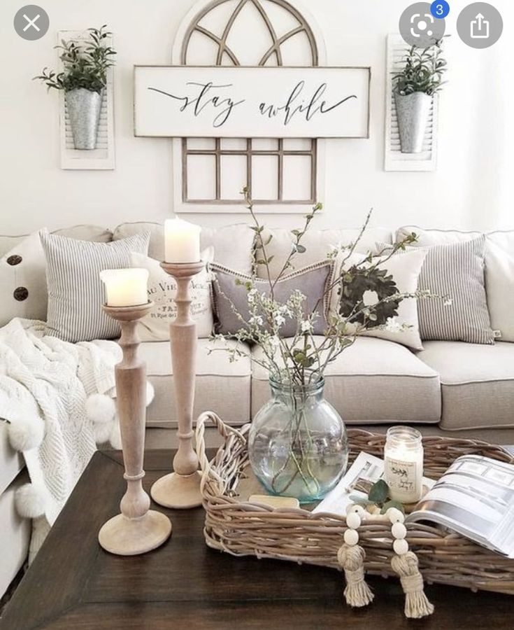 a living room filled with lots of furniture and decor on top of a wooden table