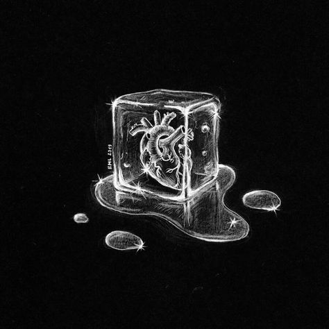 an ice cube with a heart in it and some bubbles on the ground next to it