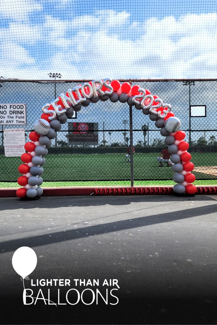 an arch made out of balloons on the side of a baseball field that reads, brighter than air balloons