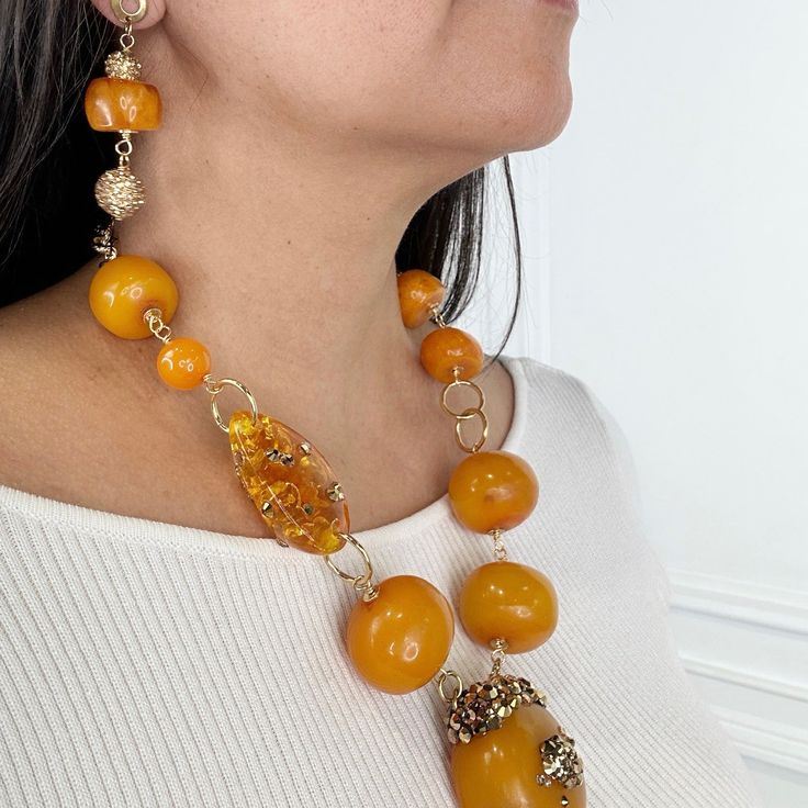 Amber Necklace. Embellished with Swarovski Crystals Necklace Earring Set. TWO OF A KIND DESIGNMETAL: Stainless SteelAPPROX SIZE: 22" Adjustable Length - Earring 2"CLOSURE: Lobster Claw Clasp Amber Round Beads Jewelry For Formal Occasions, Formal Amber Jewelry With Round Beads, Unique Amber Jewelry With Matching Earrings, Luxury Amber Jewelry With Matching Earrings, Luxury Handmade Orange Jewelry, Amber Round Beaded Jewelry, Amber Jewelry With Large Beads, Amber Jewelry With Large Round Beads, Round Amber Jewelry With Large Beads