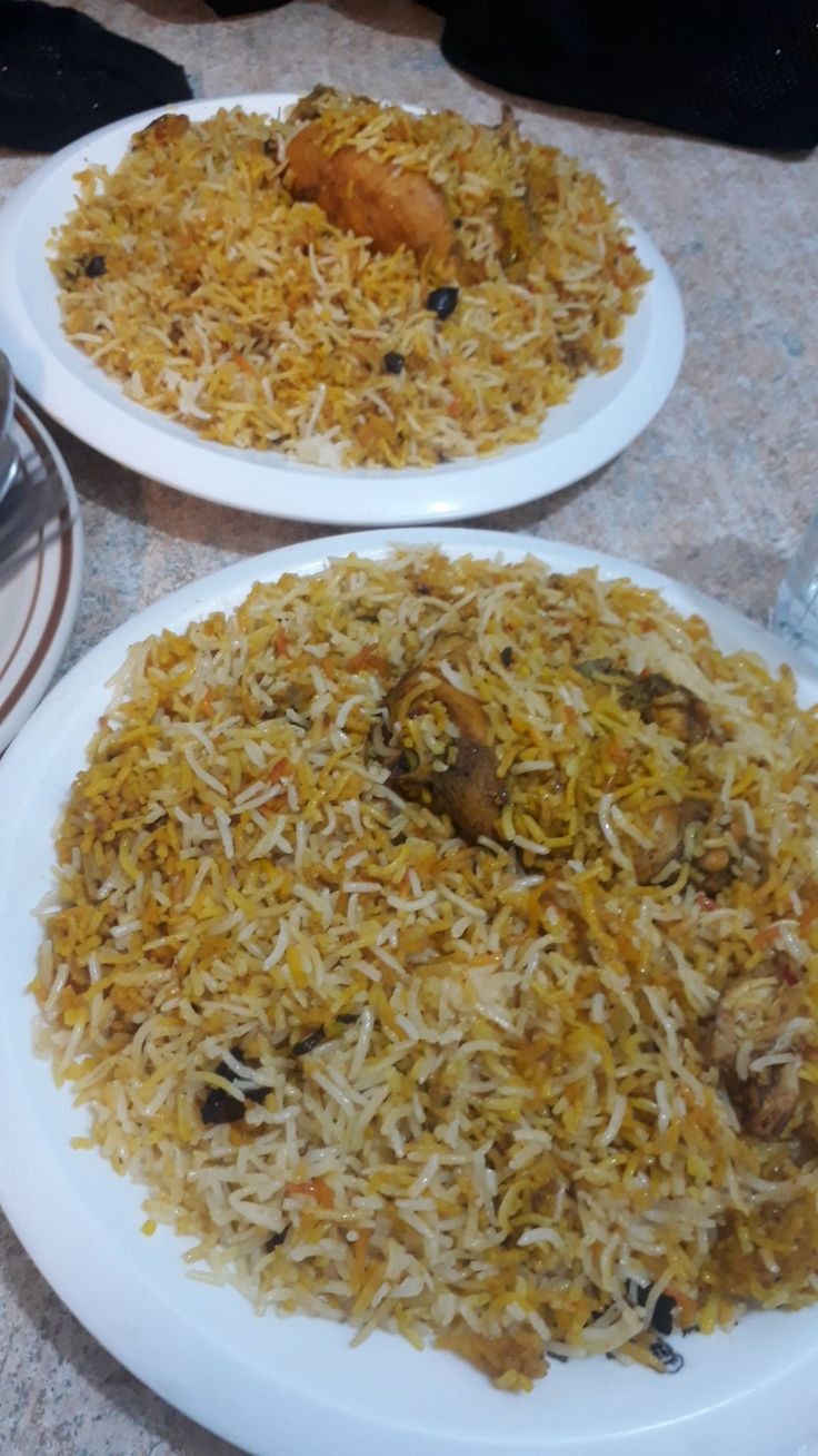 two plates filled with food sitting on top of a table