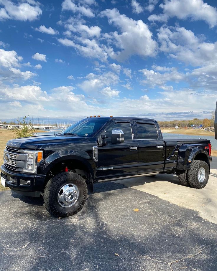 a large black truck parked in a parking lot