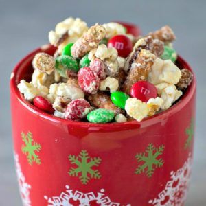 a red bowl filled with christmas treats on top of a table