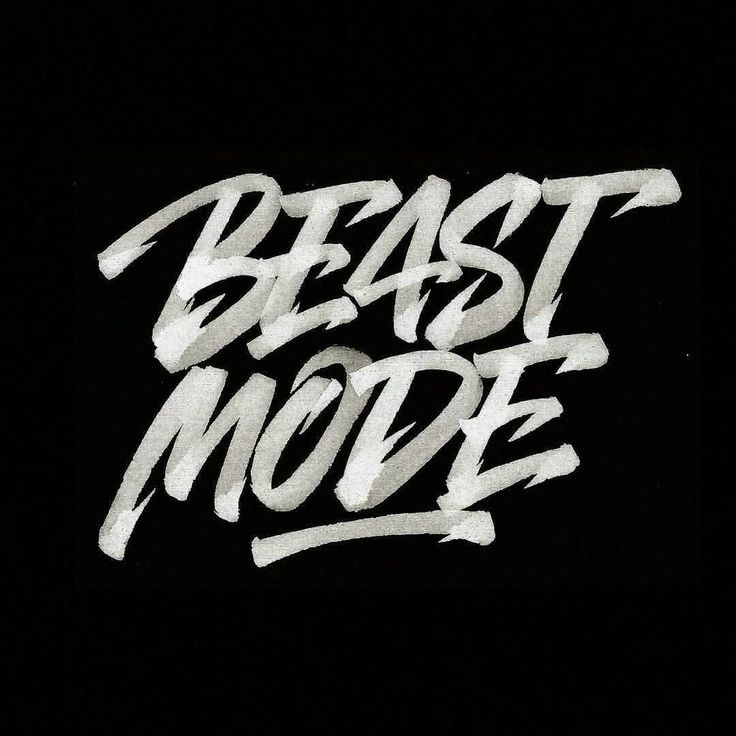 the words beast mode are written in white ink on a black background, and it appears to be graffiti