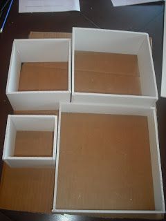 four white boxes sitting on top of a table