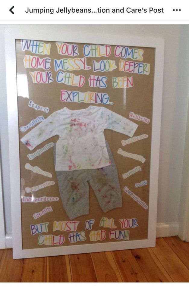 a child's paper cutout is displayed in front of a door with words written on it