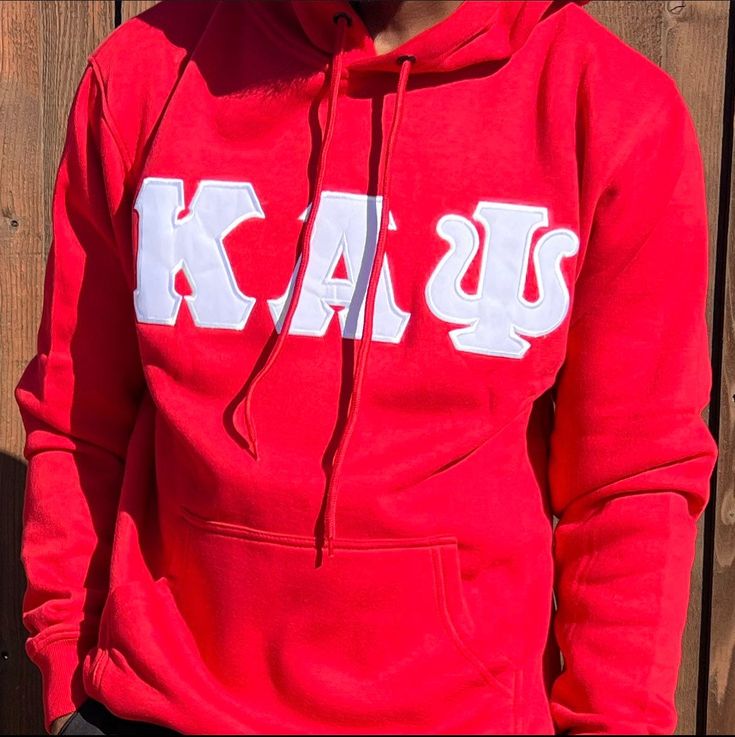 Exclusive Kappa Alpha Psi Double Stitched Appliqué Embroidery Lettered Hoodie. This is the perfect long-sleeved hoodie to wear while showing off your Kappa Alpha Psi fraternity lettering. A comfortable 100% cotton tee with a twill Greek letters embroidery across the chest give you the perfect fit. This hoodie is also a perfect gift for your favorite Kappa Man. Fast Shipping & Processing: 1-2 days to process US Domestic Shipping: 3-5 business days International Shipping: 7-14 business Cotton Varsity Hoodie With Long Sleeves, Winter Long Sleeve Hoodie With Embroidered Logo, Red College Hoodie With Letter Print, College Red Hoodie With Letter Print, Red Hoodie With Letter Print For College, University Red Collegiate Long Sleeve Hoodie, Red Letter Print Hoodie For College, University Red Long Sleeve Collegiate Hoodie, Collegiate Red Hoodie With Letter Print