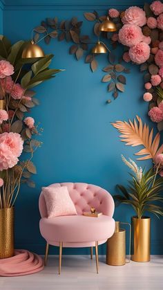 a room with blue walls, pink chairs and gold vases filled with flowers on the floor