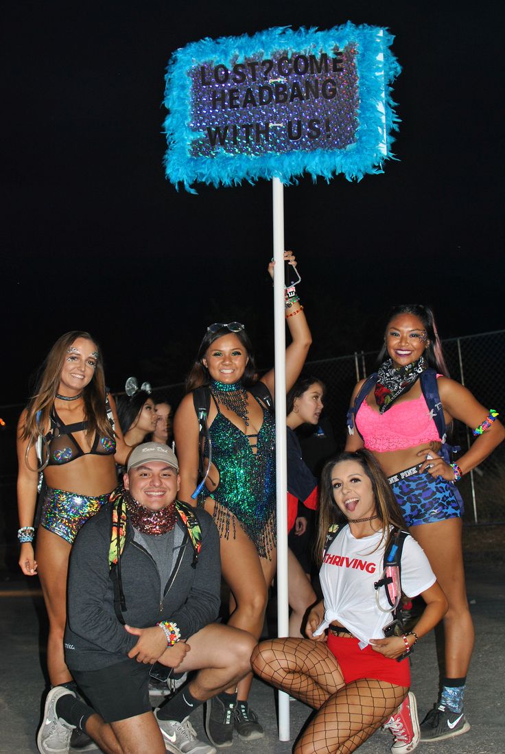 a group of people posing for a photo in front of a sign