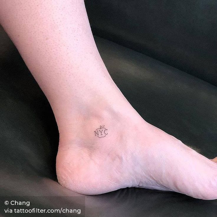 a person's foot with a small tattoo on the top of their left leg