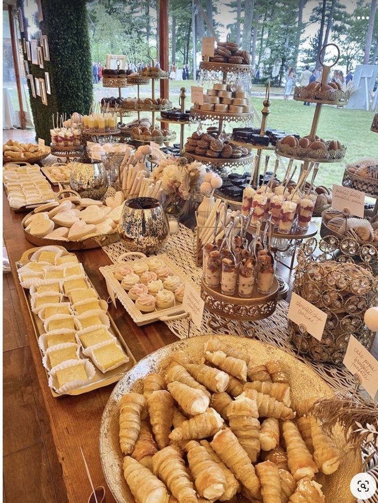 an assortment of pastries and desserts displayed on a table