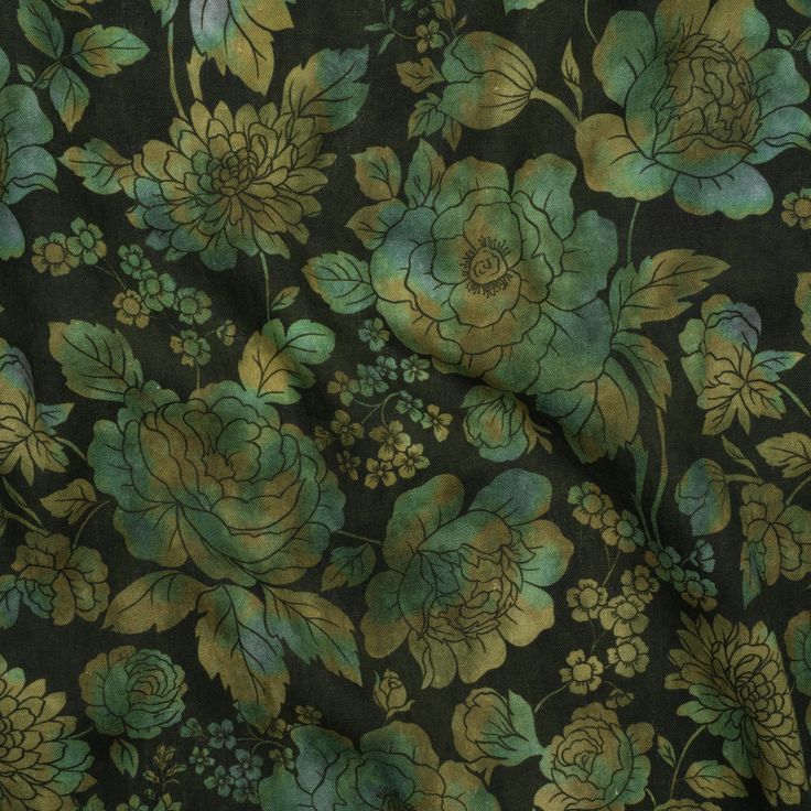 a green and gold floral print fabric with large flowers on black background, closeup