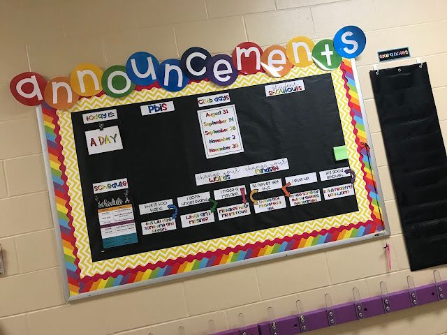 a bulletin board with the words announcements written on it in front of a classroom wall