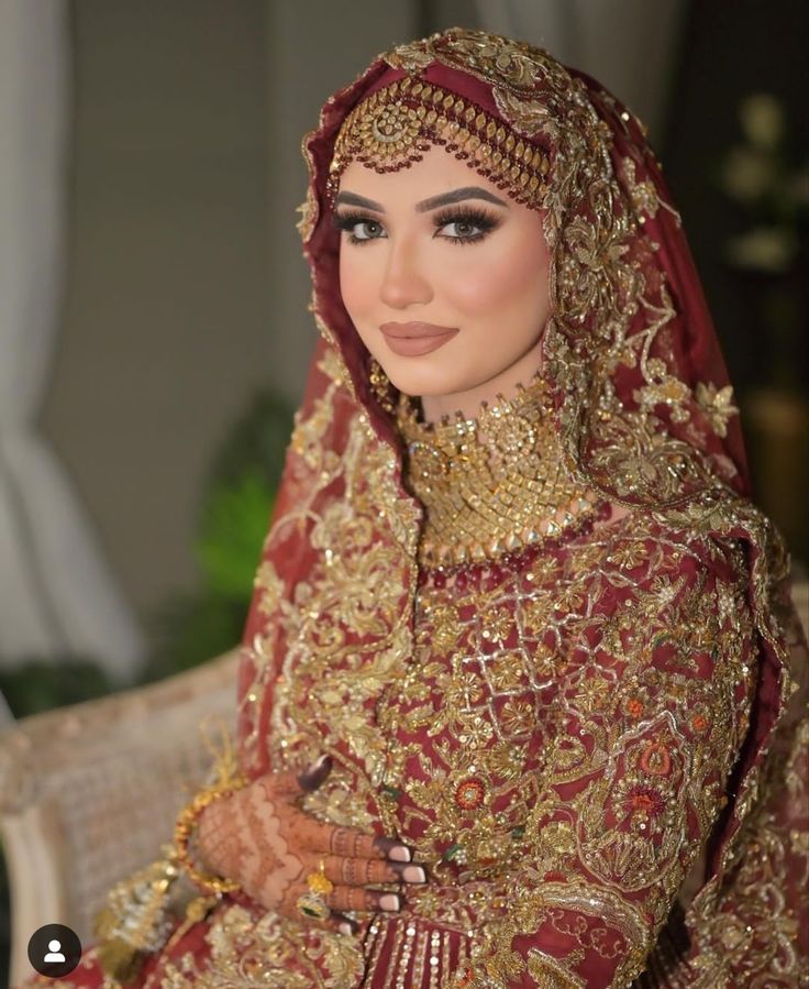 a woman in a red and gold wedding outfit