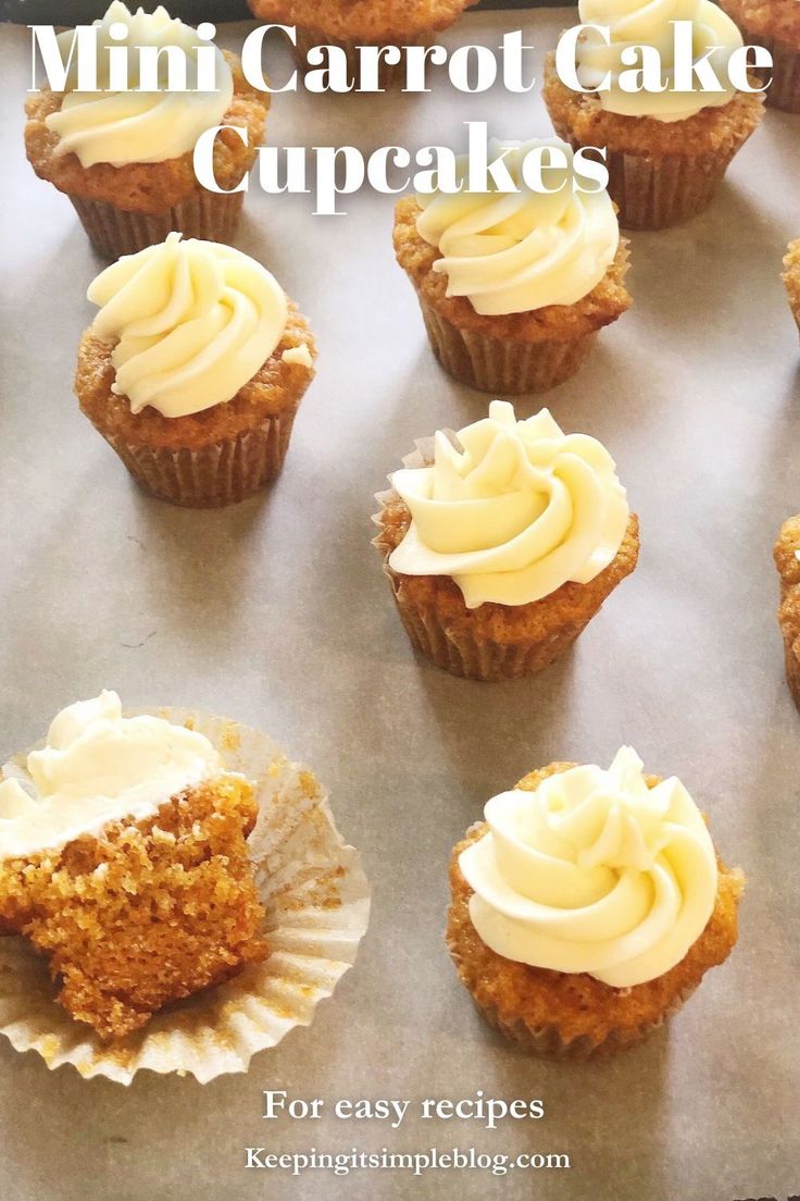 mini carrot cake cupcakes with white frosting on a baking sheet, ready to be eaten