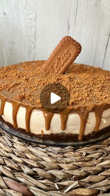 a cake sitting on top of a wicker basket covered in frosting and caramel