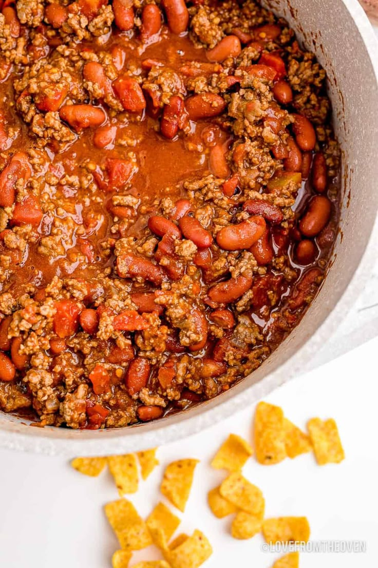 a pot full of chili and beans with tortilla chips