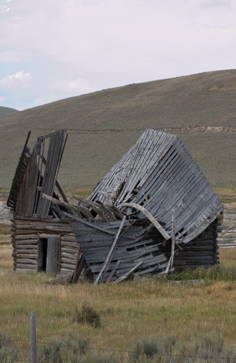 an old wooden building in the middle of nowhere